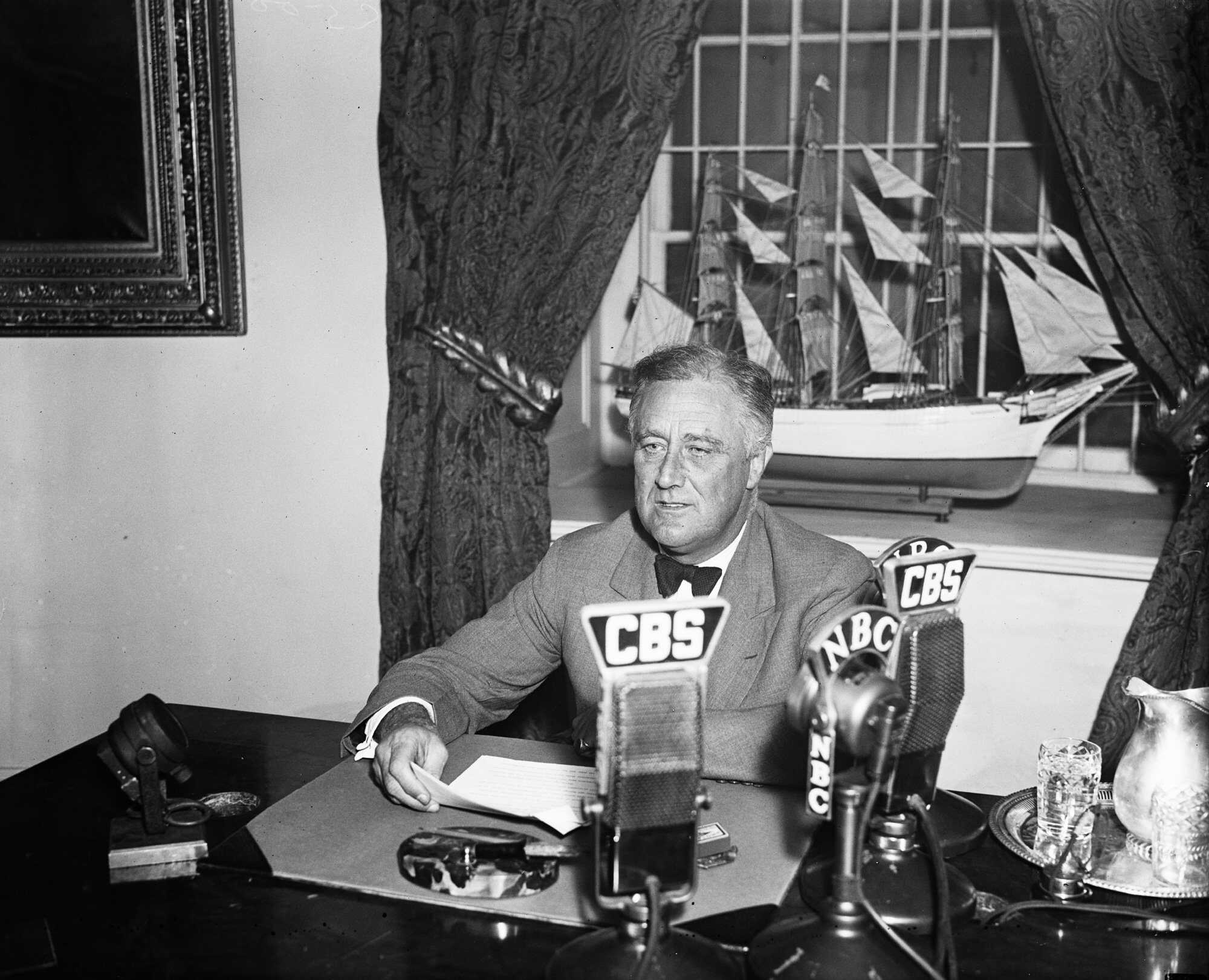 FDR speaks into NBC and CBS microphones.