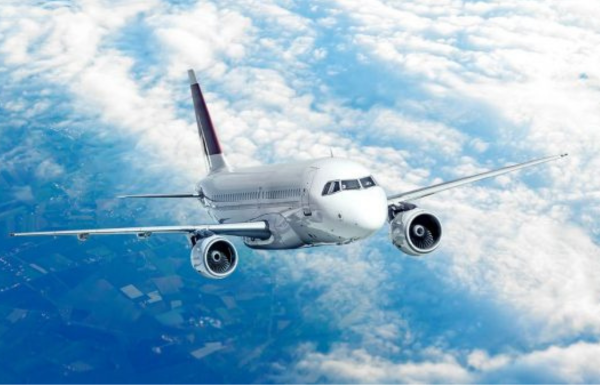 Jumbo Jet A 747 soars through the blue sky.
